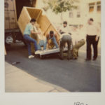 Living without a loading dock, Optikos employees load product onto a crate for shipment - 1992