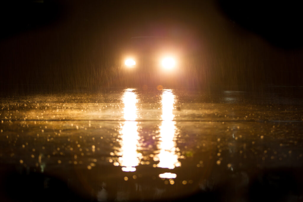 Yellow,Headlight,And,Road,In,The,Dark,While,Heavy,Raining. Automotive stray light testing